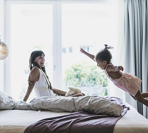 Woman and child playing in a room in the family hotel Sonnen Resort