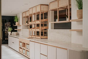 Eine stilvolle Küchentheke im Design Hotel Sonnen Resort Naturns mit schön angerichteten Tellern und modernem Interieur.
