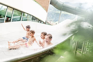 Children playing on the slides in the wellness hotel Sonnen Resort Naturns