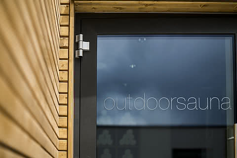 Door to the outdoor sauna in the wellness hotel Sonnen Resort in Naturns